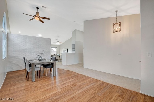 832 Seco Verde Ave, Henderson, NV 89015 - dining space featuring ceiling fan, lofted ceiling, a chandelier, light wood-style floors, and baseboards