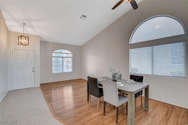 832 Seco Verde Ave, Henderson, NV 89015 - dining room with a chandelier, vaulted ceiling, a ceiling fan, baseboards, and light tile patterned floors
