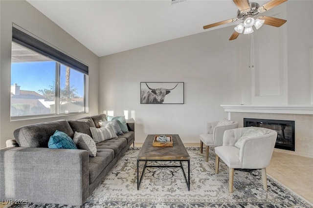 832 Seco Verde Ave, Henderson, NV 89015 - living room featuring vaulted ceiling, a fireplace, a ceiling fan, and light tile patterned floors