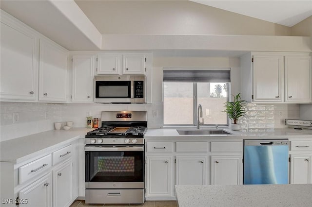 832 Seco Verde Ave, Henderson, NV 89015 - kitchen featuring appliances with stainless steel finishes, a sink, white cabinets, light countertops, and decorative backsplash
