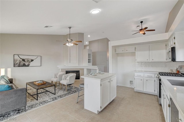 832 Seco Verde Ave, Henderson, NV 89015 - kitchen featuring a ceiling fan, appliances with stainless steel finishes, open floor plan, lofted ceiling, and recessed lighting