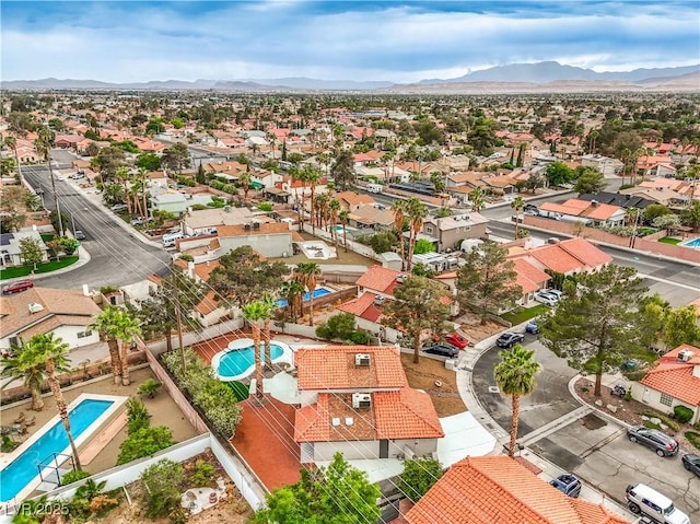 aerial view of residential area featuring a pool area and mountains