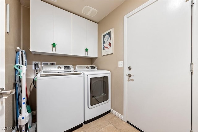 3966 E Garfield Dr, Pahrump, NV 89061 - washroom with washing machine and clothes dryer, cabinet space, light tile patterned flooring, and baseboards