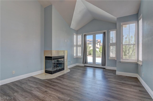 8300 Slate Harbor Cir, Las Vegas, NV 89128 - unfurnished living room with wood finished floors, a fireplace, baseboards, and vaulted ceiling