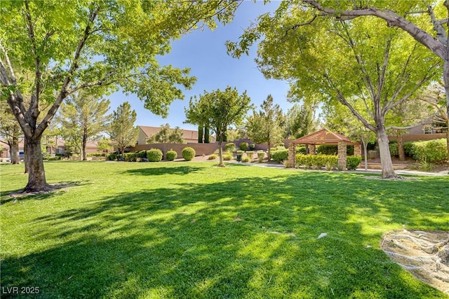 view of property's community with a gazebo and a lawn