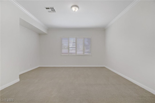 empty room featuring carpet floors, ornamental molding, and baseboards