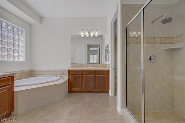 full bath with a stall shower, a garden tub, vanity, and tile patterned flooring