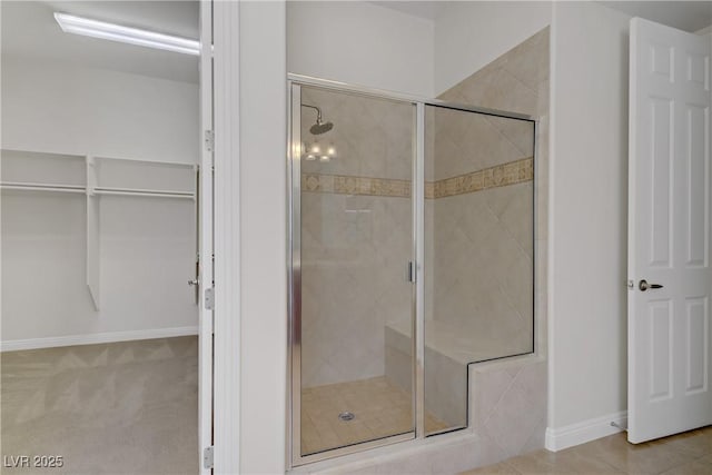 full bath featuring a stall shower and baseboards