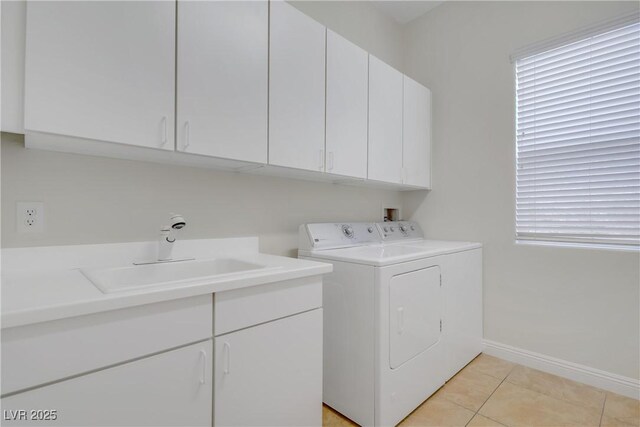 936 Viscanio Pl, Las Vegas, NV 89138 - washroom with cabinet space, washer and dryer, baseboards, and light tile patterned flooring