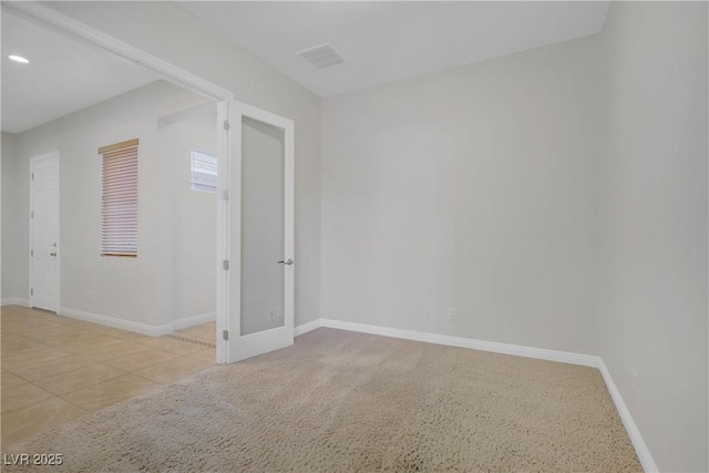 spare room with baseboards and recessed lighting