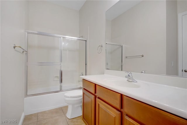 full bath with tile patterned flooring, toilet, vanity, and shower / bath combination with glass door