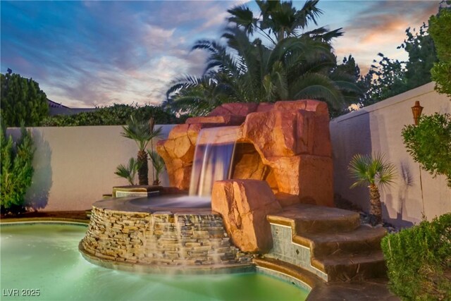 936 Viscanio Pl, Las Vegas, NV 89138 - pool at dusk featuring a fireplace