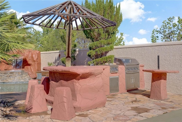 view of patio / terrace featuring exterior kitchen and grilling area