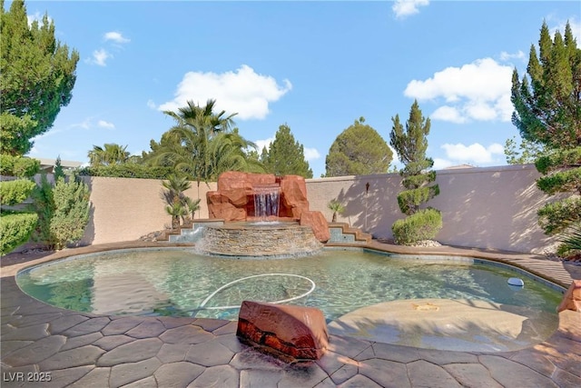 view of swimming pool with a fenced backyard