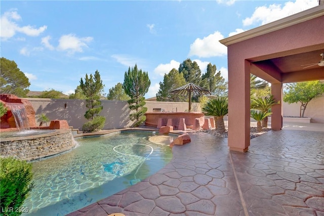 view of swimming pool featuring a patio, a fenced backyard, and ceiling fan