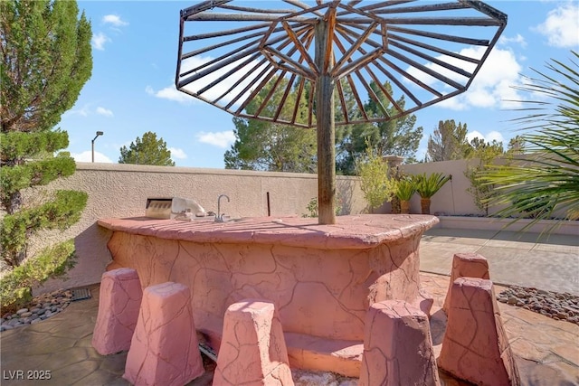 view of patio / terrace featuring fence