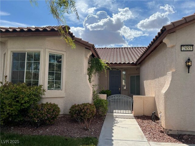2855 Grande Valley Dr, Las Vegas, NV 89135 - entrance to property with a gate, a tiled roof, and stucco siding