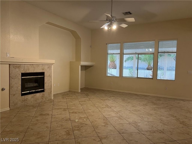 2855 Grande Valley Dr, Las Vegas, NV 89135 - unfurnished living room featuring ceiling fan, a tile fireplace, light tile patterned flooring, and baseboards