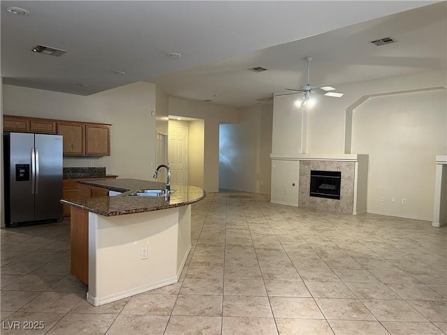2855 Grande Valley Dr, Las Vegas, NV 89135 - kitchen with stainless steel fridge with ice dispenser, a sink, open floor plan, ceiling fan, and dark stone counters