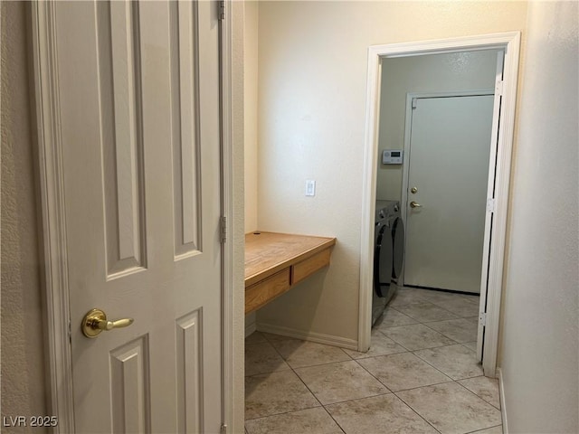 2855 Grande Valley Dr, Las Vegas, NV 89135 - hall featuring separate washer and dryer, light tile patterned floors, and baseboards