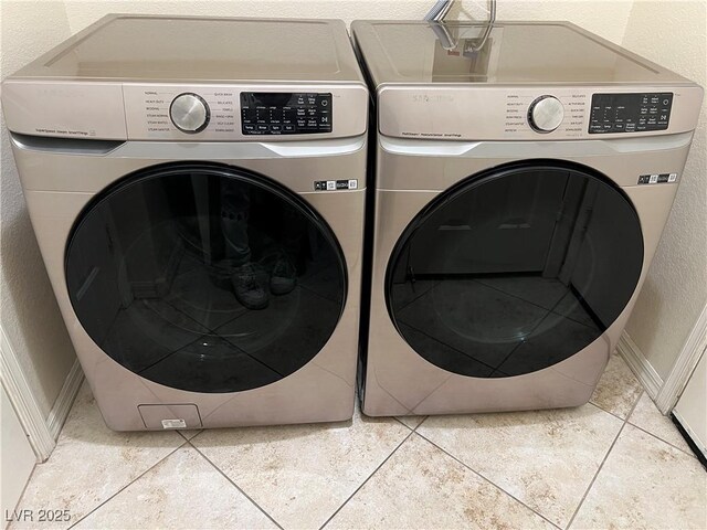 2855 Grande Valley Dr, Las Vegas, NV 89135 - laundry room featuring washing machine and clothes dryer, a textured wall, baseboards, and light tile patterned floors