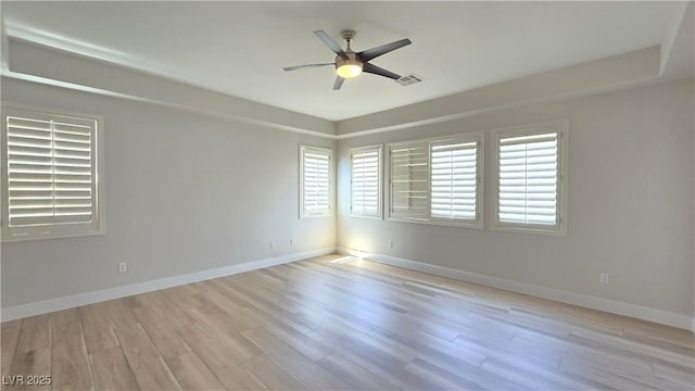 unfurnished room with a ceiling fan, light wood-style floors, and baseboards