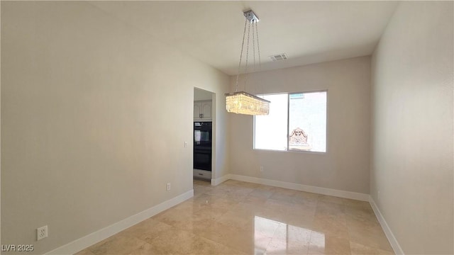 unfurnished dining area featuring a chandelier and baseboards