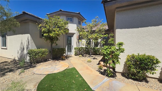 property entrance with stucco siding
