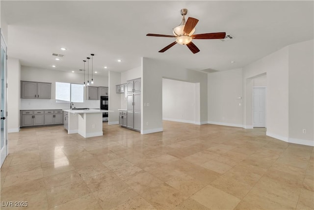 11621 La Mirago Pl, Las Vegas, NV 89138 - unfurnished living room featuring a ceiling fan, recessed lighting, and baseboards