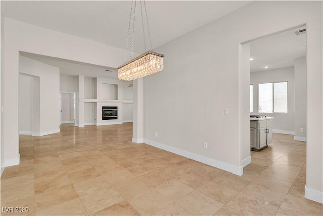 11621 La Mirago Pl, Las Vegas, NV 89138 - unfurnished living room with a glass covered fireplace, baseboards, a chandelier, and recessed lighting