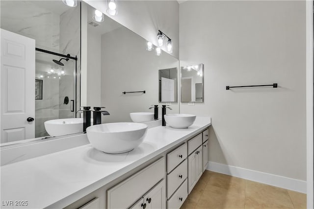 11621 La Mirago Pl, Las Vegas, NV 89138 - full bathroom featuring a shower stall, double vanity, tile patterned flooring, and baseboards