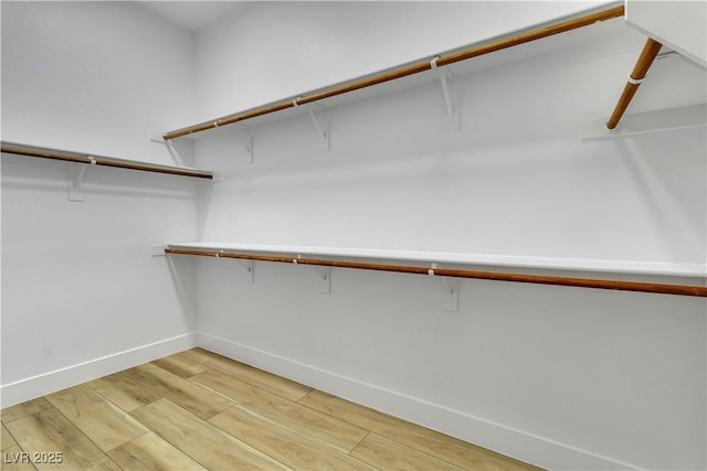 11621 La Mirago Pl, Las Vegas, NV 89138 - walk in closet with light wood-type flooring