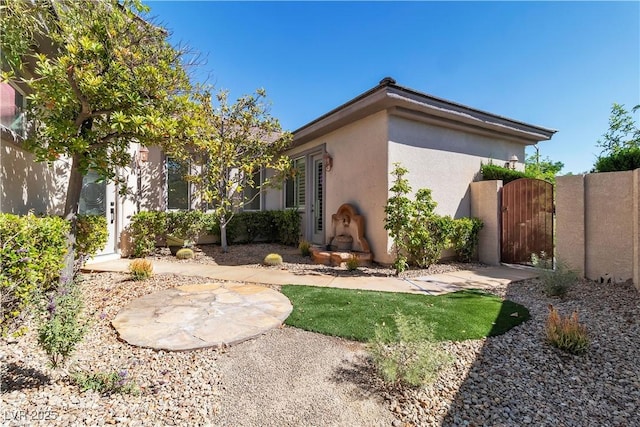 11621 La Mirago Pl, Las Vegas, NV 89138 - view of side of home featuring stucco siding and a gate
