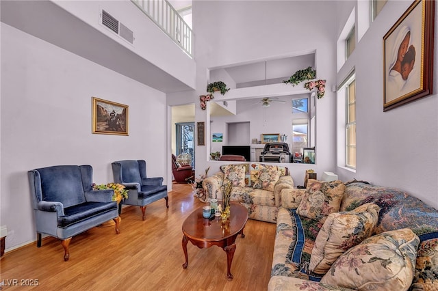 2180 Polynesia Cir, Henderson, NV 89074 - living area with a towering ceiling, healthy amount of natural light, light wood finished floors, and ceiling fan