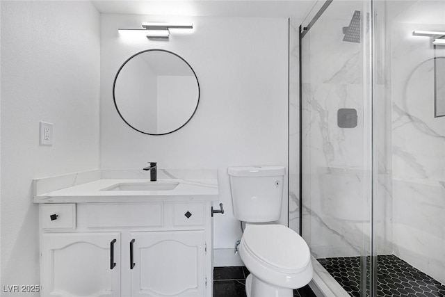 full bathroom featuring a marble finish shower, vanity, and toilet