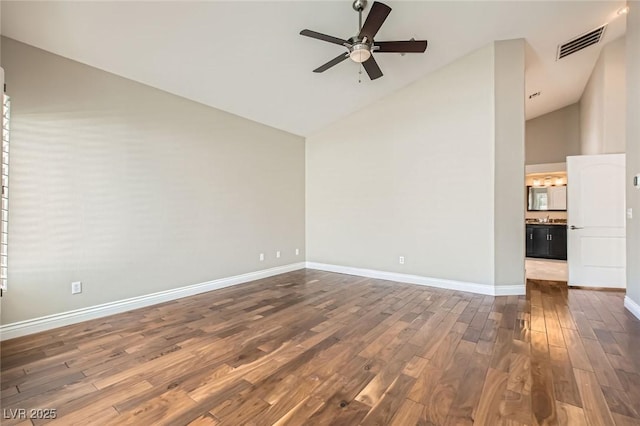 8124 Bay Harbor Dr, Las Vegas, NV 89128 - spare room with high vaulted ceiling, dark wood-type flooring, ceiling fan, and baseboards