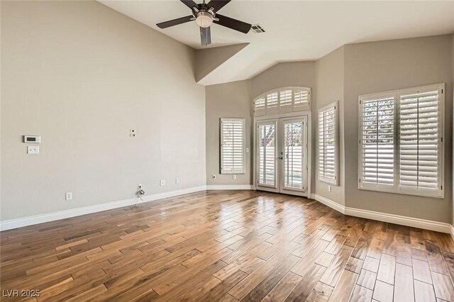 8124 Bay Harbor Dr, Las Vegas, NV 89128 - spare room featuring ceiling fan, wood finished floors, baseboards, and high vaulted ceiling