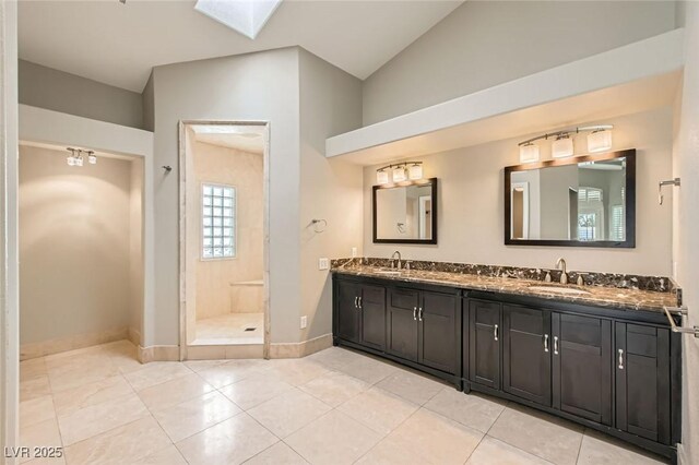 8124 Bay Harbor Dr, Las Vegas, NV 89128 - bathroom with double vanity, a stall shower, a skylight, baseboards, and tile patterned floors