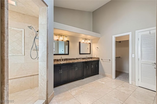 8124 Bay Harbor Dr, Las Vegas, NV 89128 - full bath featuring double vanity, a walk in shower, a towering ceiling, tile patterned floors, and a closet
