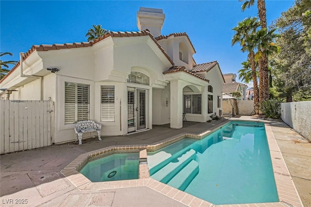 8124 Bay Harbor Dr, Las Vegas, NV 89128 - back of house with a tiled roof, a chimney, stucco siding, and french doors