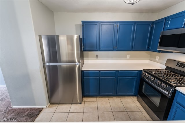 350 S Durango Dr Unit 108, Las Vegas, NV 89145 - kitchen featuring stainless steel appliances, blue cabinets, light countertops, and light tile patterned floors