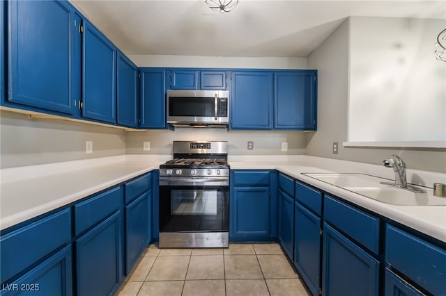 350 S Durango Dr Unit 108, Las Vegas, NV 89145 - kitchen with appliances with stainless steel finishes, a sink, light countertops, light tile patterned flooring, and blue cabinetry