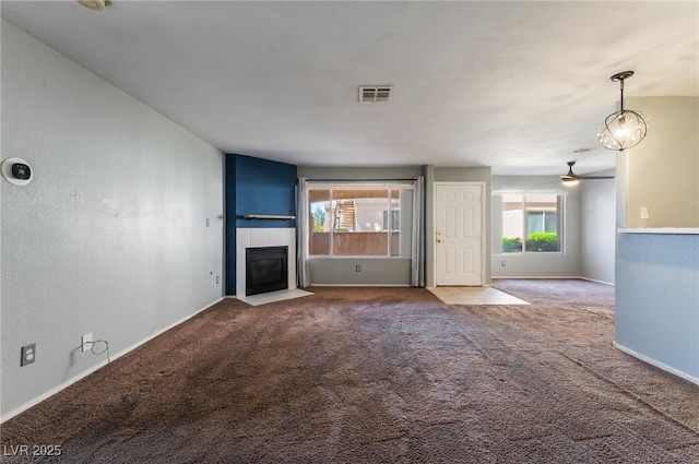 350 S Durango Dr Unit 108, Las Vegas, NV 89145 - unfurnished living room featuring a tile fireplace, carpet, ceiling fan, and baseboards