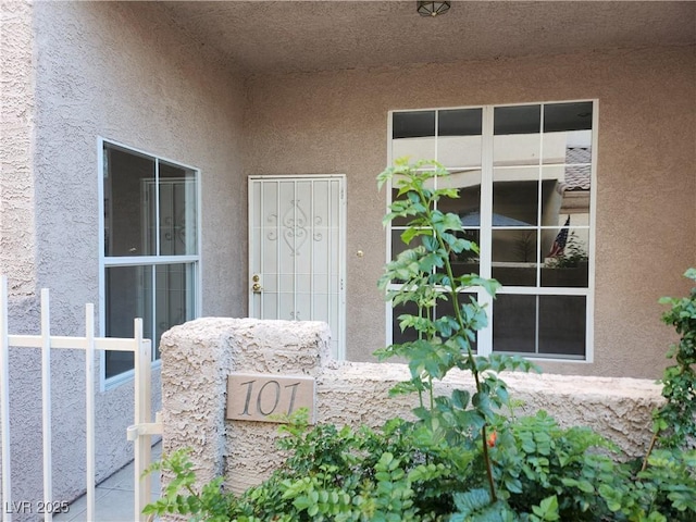 view of exterior entry with stucco siding