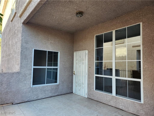 doorway to property featuring stucco siding