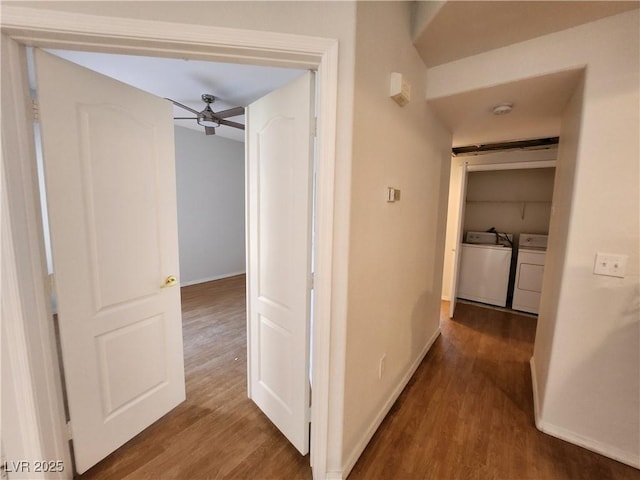 hall with washing machine and clothes dryer, wood finished floors, and baseboards