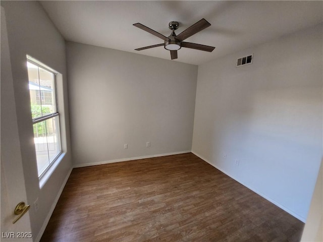 empty room featuring wood finished floors, ceiling fan, and baseboards