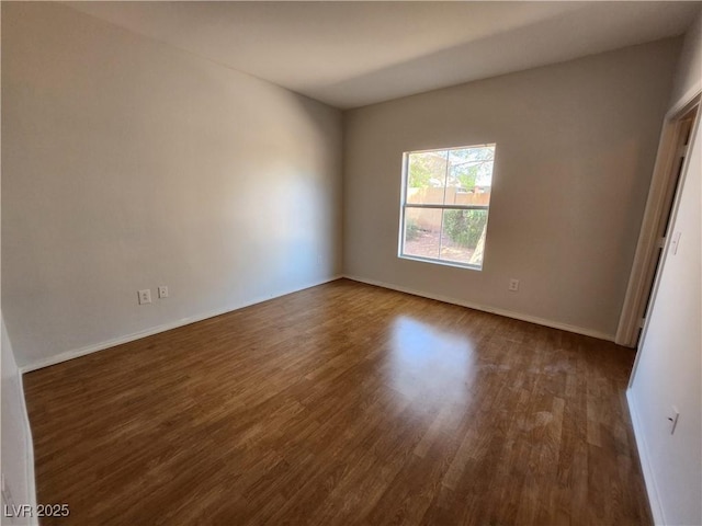 unfurnished room with wood finished floors and baseboards