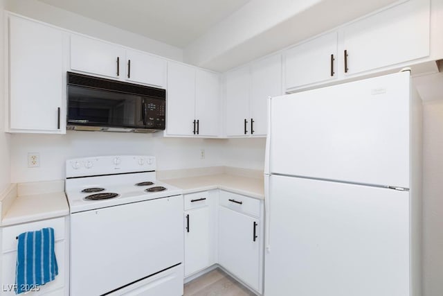 kitchen featuring white appliances, light countertops, and white cabinetry