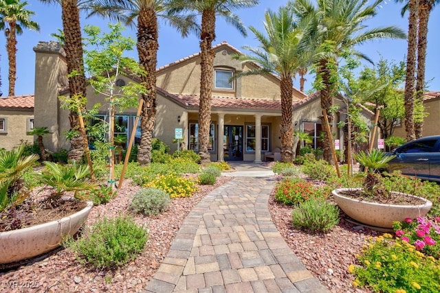 view of front of home featuring stucco siding and a tiled roof